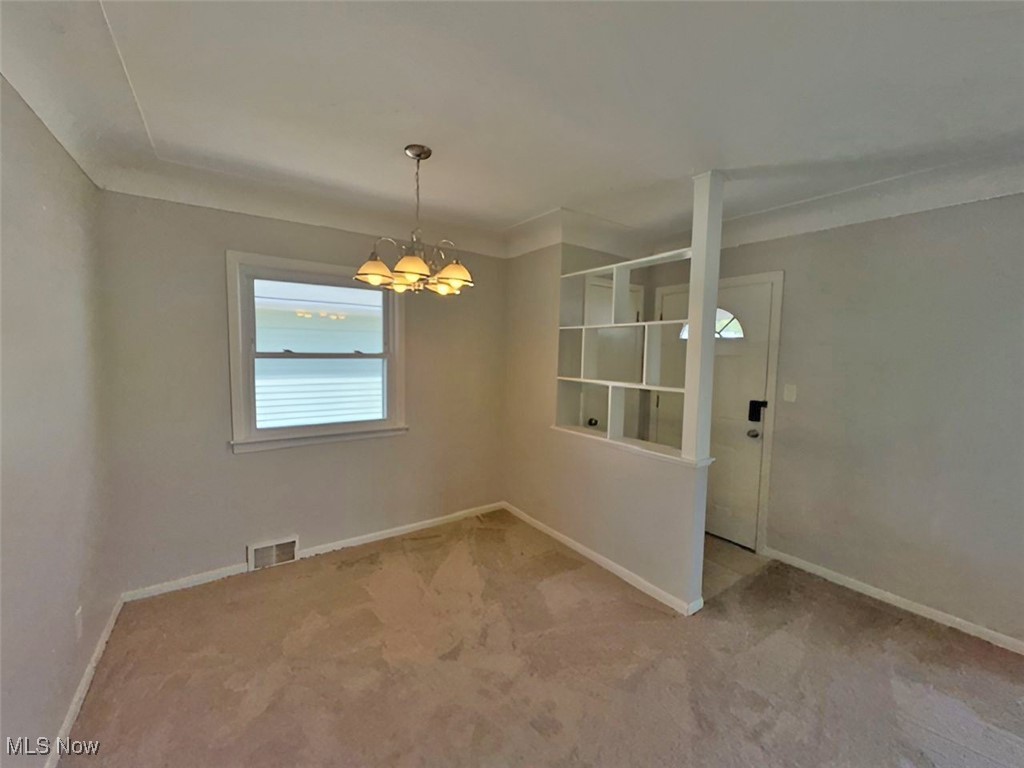 28642 Forest Road Willowick, OH 44095 - Photo 10 of 23 Spare room with a chandelier and light carpet