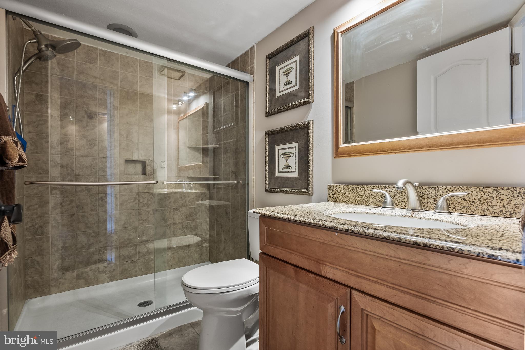 511 Chanticleer Cherry Hill, NJ 08003 - Photo 19 of 24 a bathroom with a granite countertop sink a toilet and shower