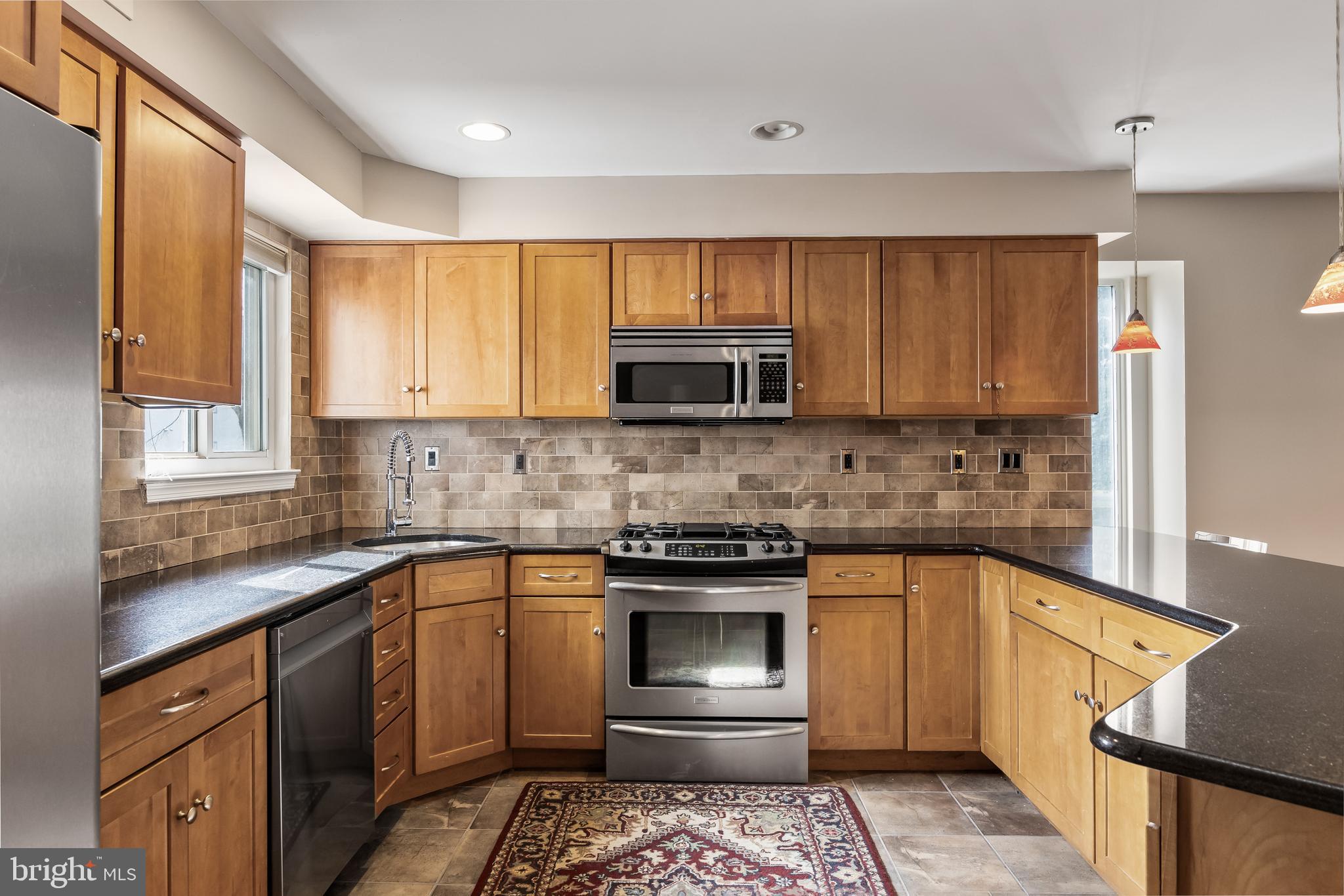 511 Chanticleer Cherry Hill, NJ 08003 - Photo 9 of 24 a kitchen with a sink stove and microwave