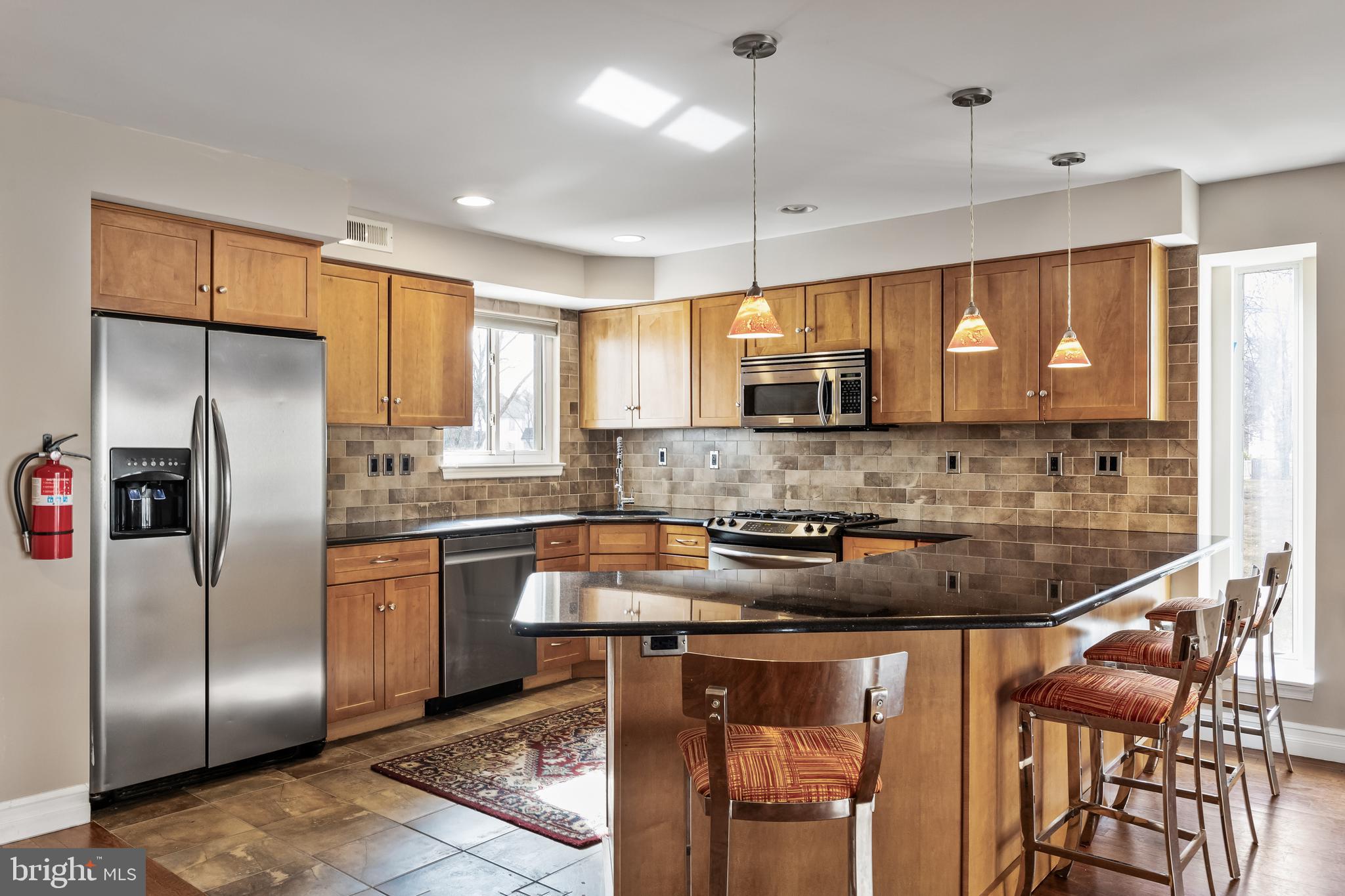 511 Chanticleer Cherry Hill, NJ 08003 - Photo 10 of 24 a kitchen with stainless steel appliances granite countertop a refrigerator a stove a sink and a microwave