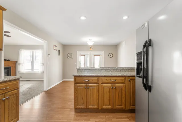 a view of a kitchen with a sink and a refrigerator