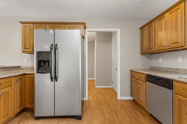 a kitchen with a refrigerator and cabinets