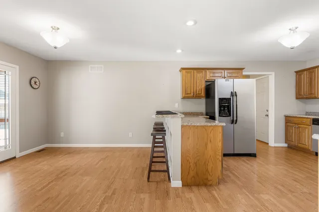 a view of kitchen with furniture and wooden floor