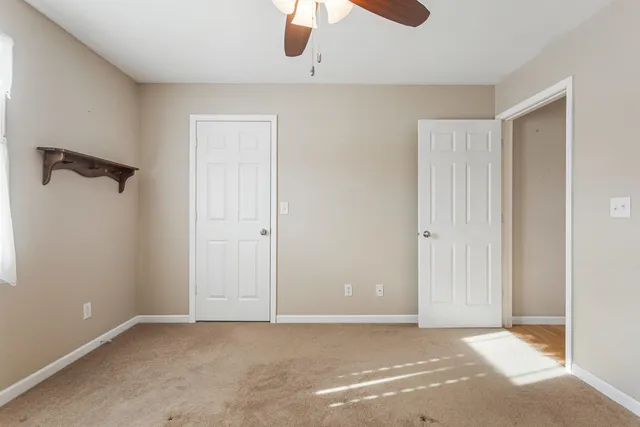 a bathroom with a sink toilet and a window