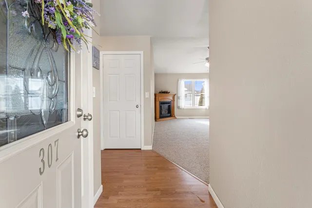 a view of hallway with wooden floor and a potted plant