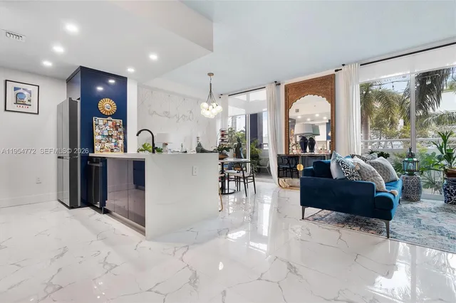 a living room with fireplace furniture and a large window