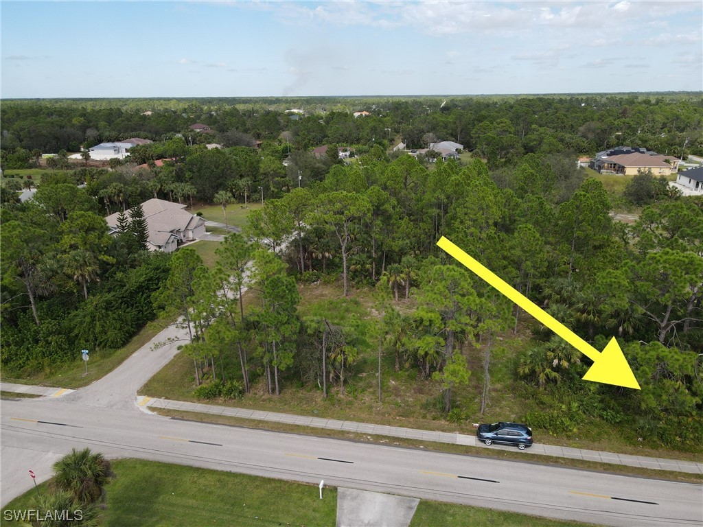 103 East 6th Street Lehigh Acres, FL 33972 - Photo 2 of 3 an aerial view of residential houses with outdoor space and trees