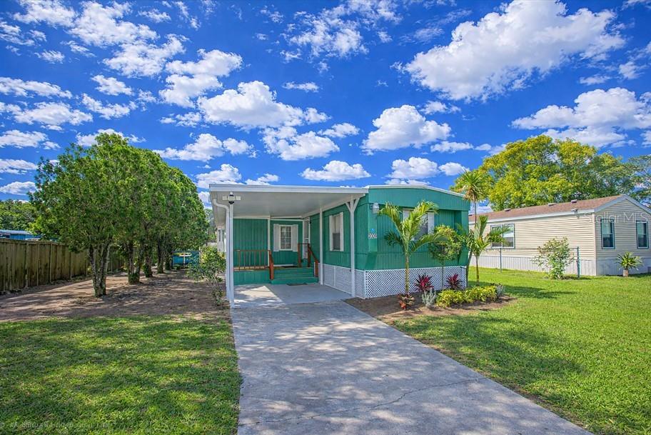 2009 Pine Street St. Cloud, FL 34769 - Photo 1 of 17 a view of a house with backyard and a tree