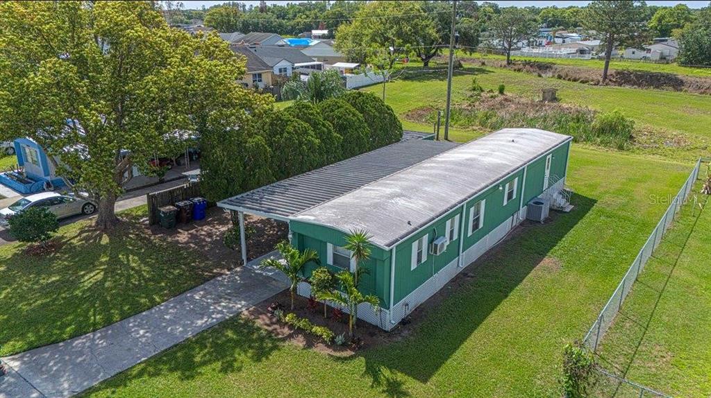 2009 Pine Street St. Cloud, FL 34769 - Photo 14 of 17 a view of a house with a big yard