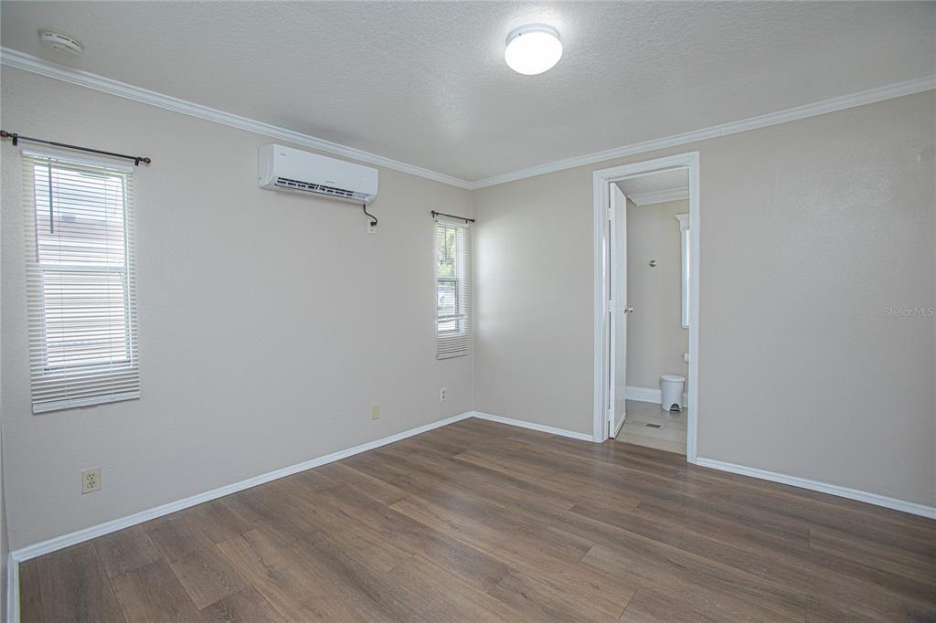 2009 Pine Street St. Cloud, FL 34769 - Photo 5 of 17 an empty room with wooden floor and windows