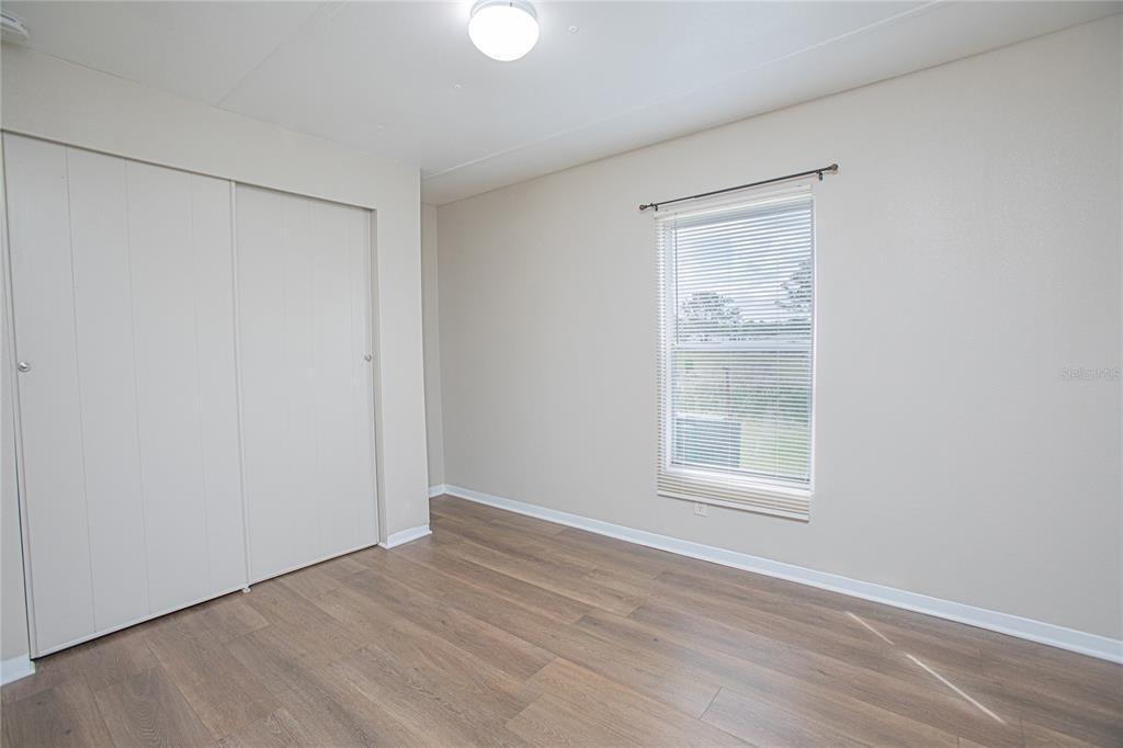 2009 Pine Street St. Cloud, FL 34769 - Photo 10 of 17 a view of an empty room with wooden floor and a window