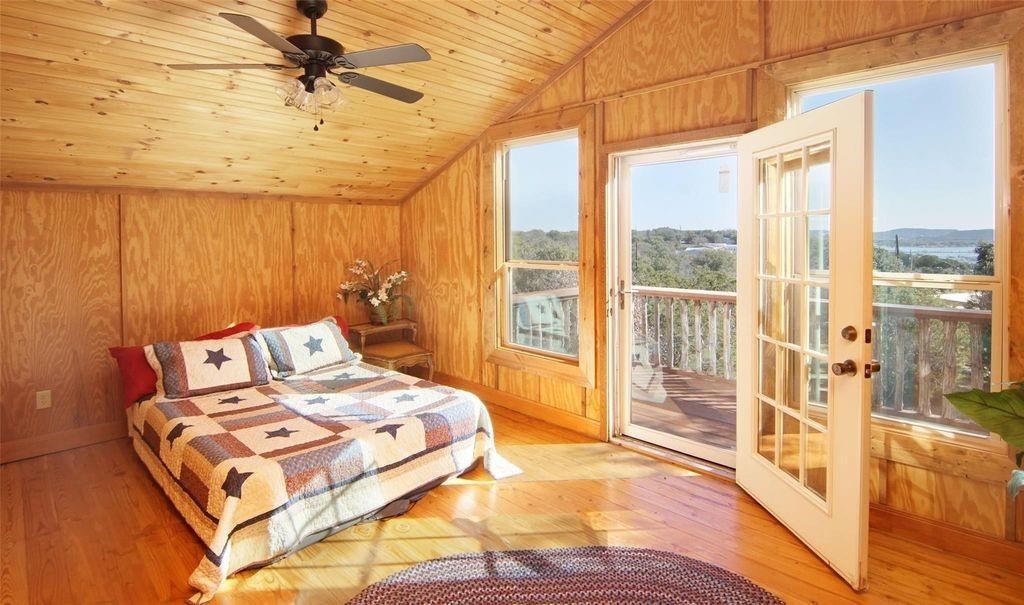 504 Doe Lane Graham, TX 76450 - Photo 14 of 27 a bedroom with a large bed and a large window