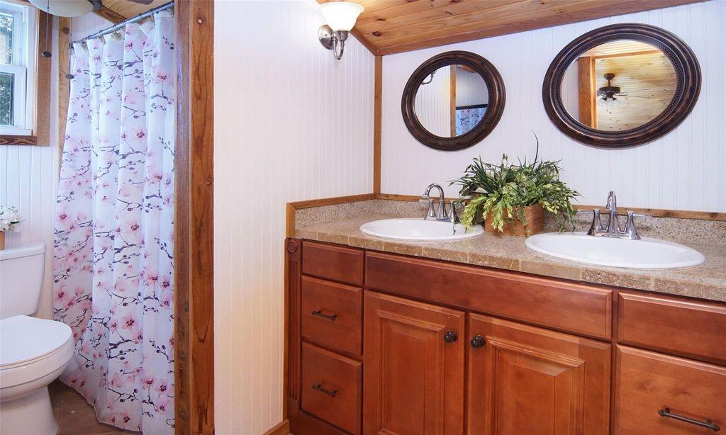 504 Doe Lane Graham, TX 76450 - Photo 17 of 27 a bathroom with a sink and a mirror