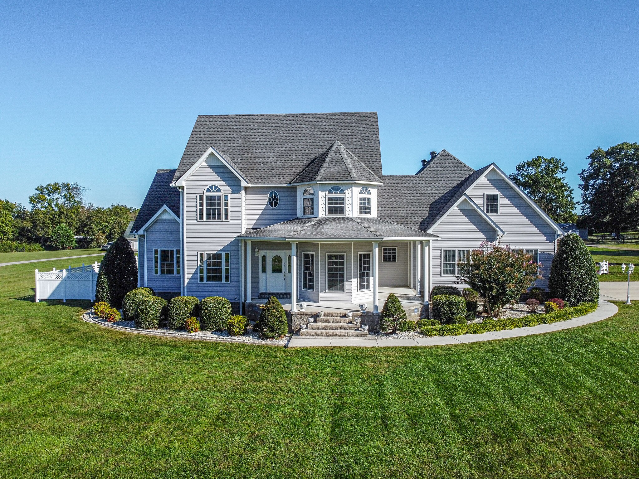 163 Harper Road Manchester, TN 37355 - Photo 1 of 43 a front view of a house with a yard table and chairs
