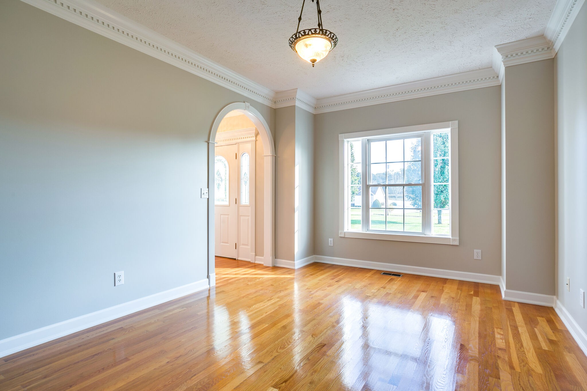 163 Harper Road Manchester, TN 37355 - Photo 11 of 43 an empty room with wooden floor and windows