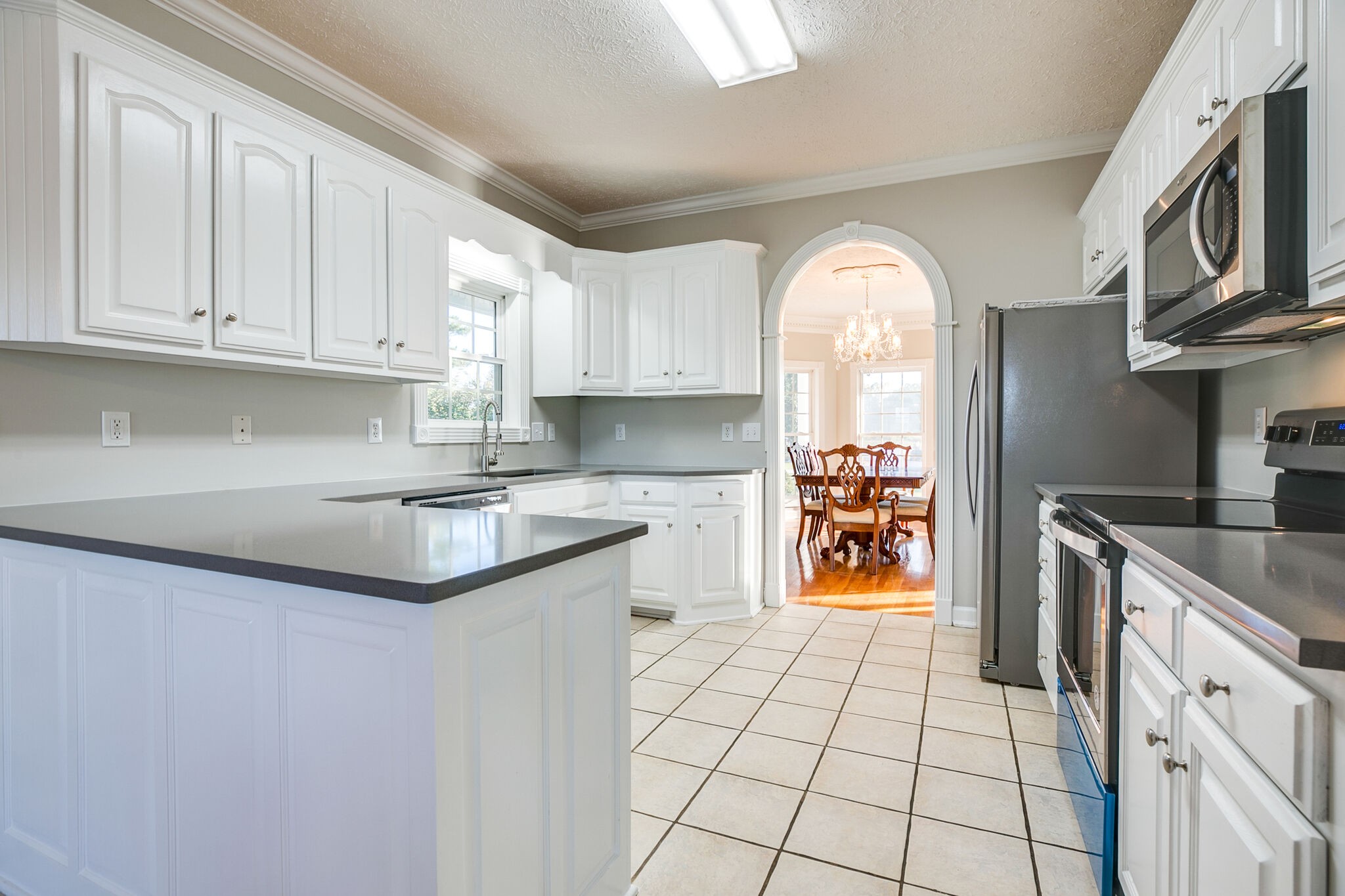 163 Harper Road Manchester, TN 37355 - Photo 16 of 43 a kitchen with stainless steel appliances granite countertop a stove a sink and a refrigerator