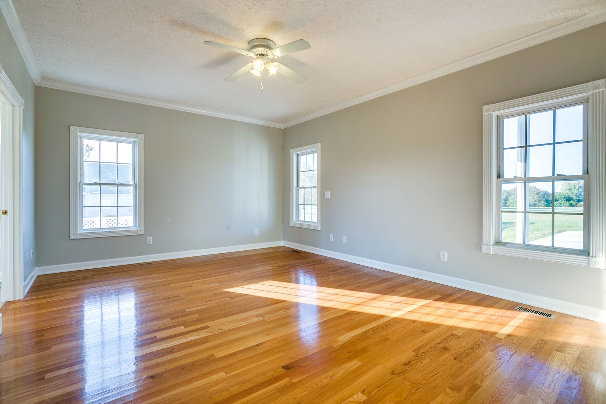163 Harper Road Manchester, TN 37355 - Photo 21 of 43 a view of an empty room with wooden floor and a window