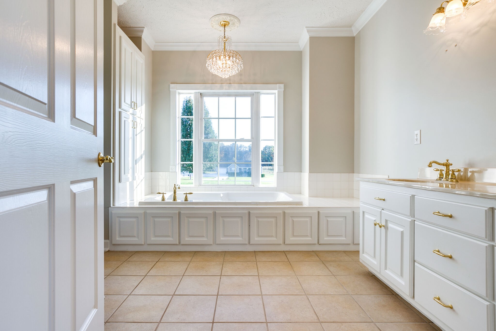 163 Harper Road Manchester, TN 37355 - Photo 23 of 43 a large white kitchen with granite countertop a white cabinets and a window