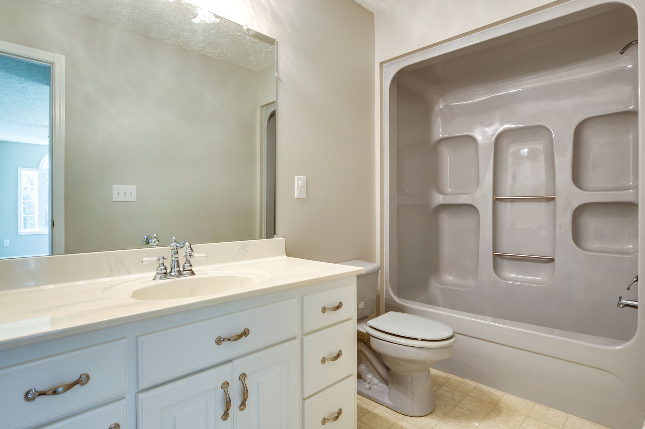 163 Harper Road Manchester, TN 37355 - Photo 32 of 43 a bathroom with a toilet a sink a mirror a shower and vanity