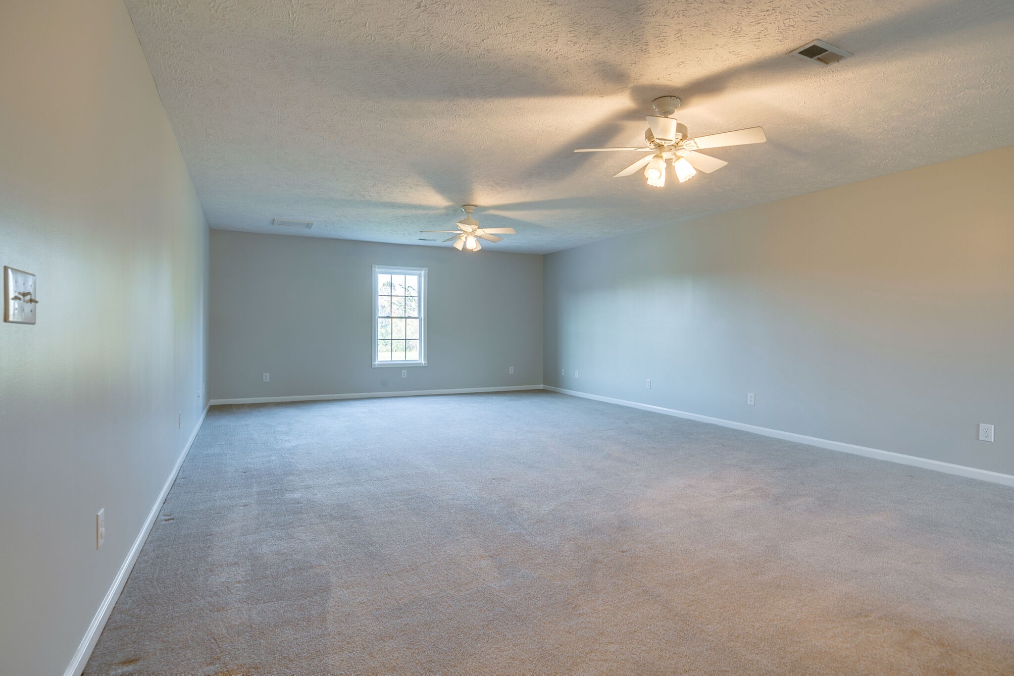 163 Harper Road Manchester, TN 37355 - Photo 36 of 43 a view of an empty room with a chandelier fan and a window