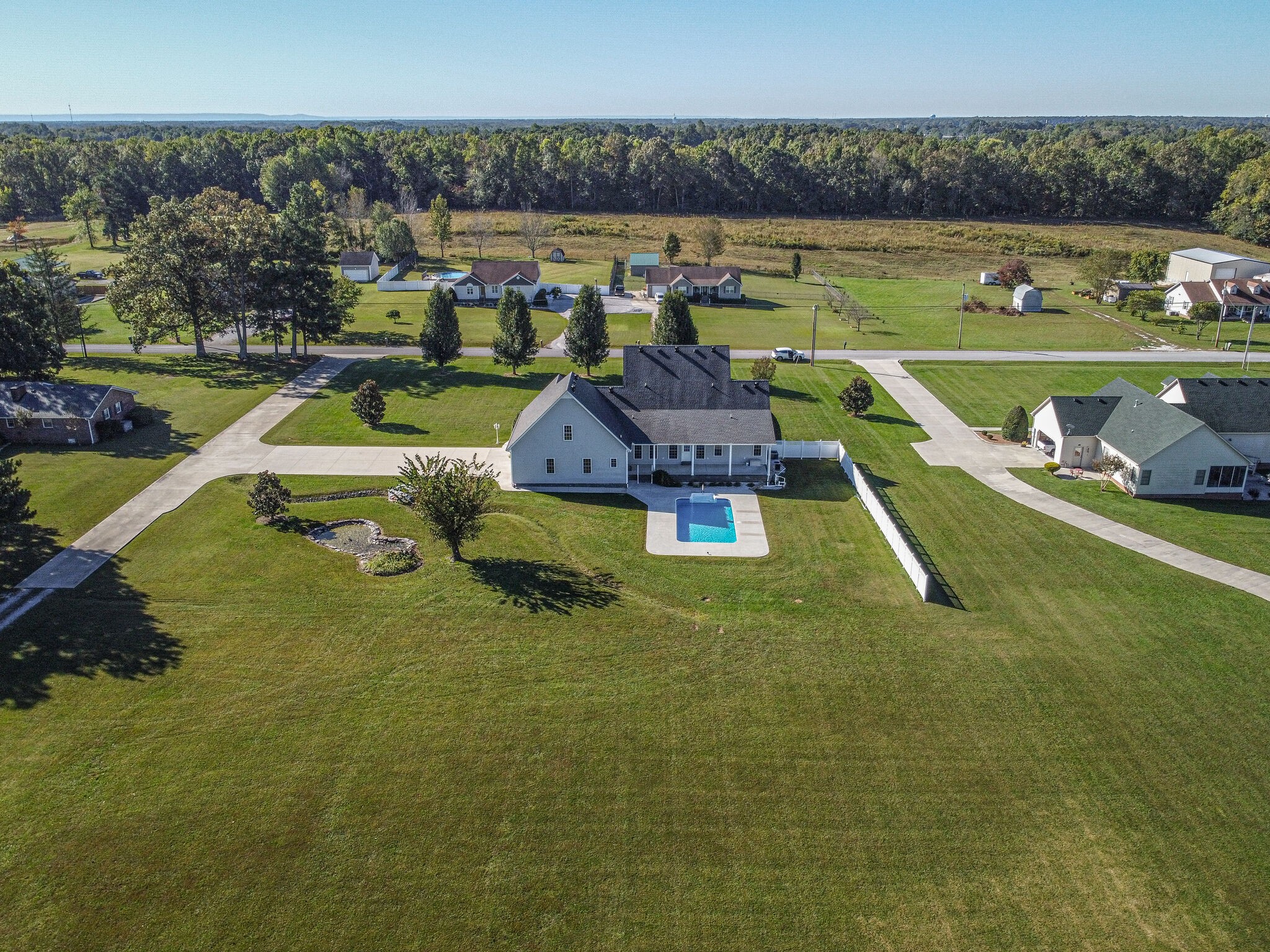 163 Harper Road Manchester, TN 37355 - Photo 43 of 43 a view of a swimming pool with lawn chairs and a table
