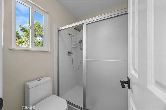 a bathroom with a toilet and a shower