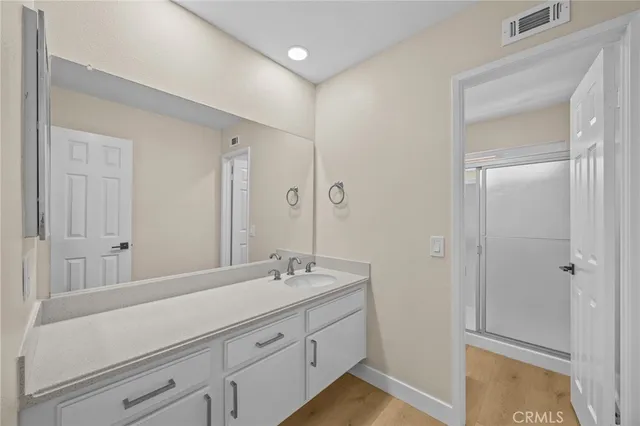 a bathroom with a double vanity sink and mirror