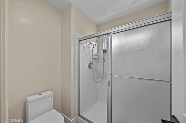 a bathroom with a shower and toilet