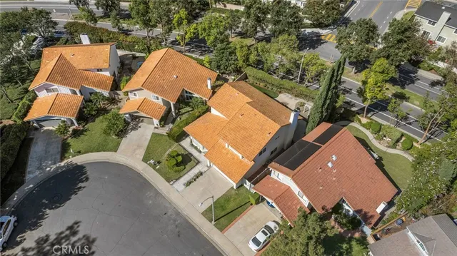 an aerial view of a house with a yard and trees