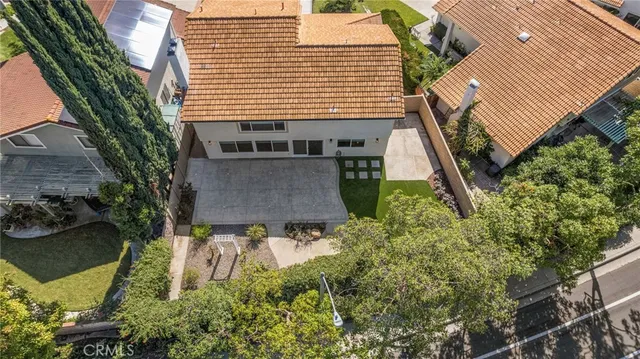 an aerial view of a house with a yard and balcony