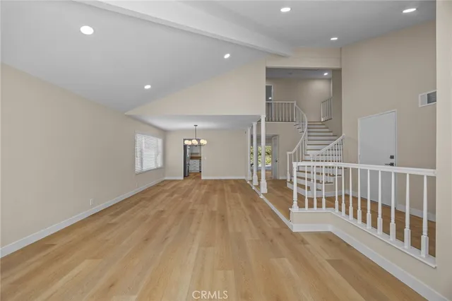 a view of a hallway with wooden floor and fence