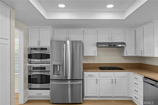 a kitchen with cabinets and stainless steel appliances
