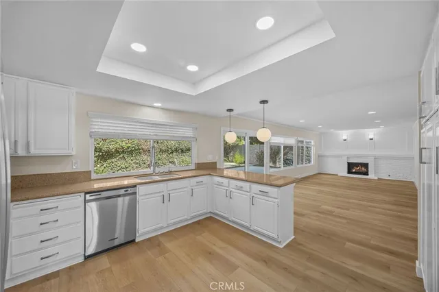 a kitchen with granite countertop a stove and white cabinets