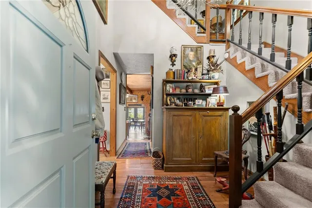 a view of an entryway with wooden floor