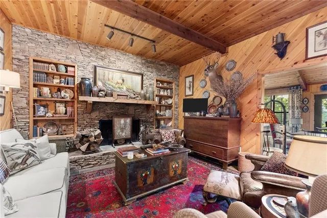 a living room with fireplace furniture and a clock