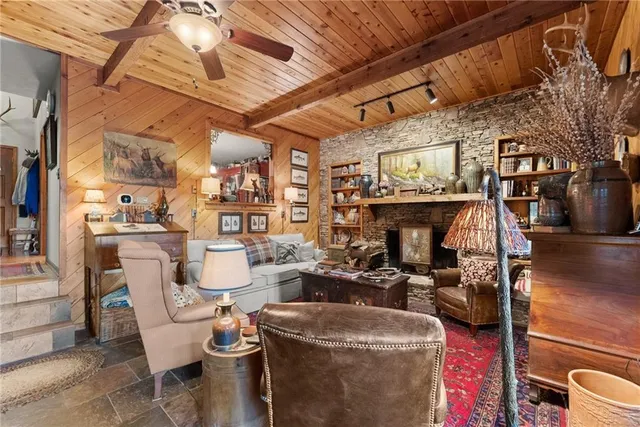 a view of a dining room with furniture a rug and wooden floor