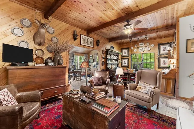a view of a dining room with furniture large windows and wooden floor