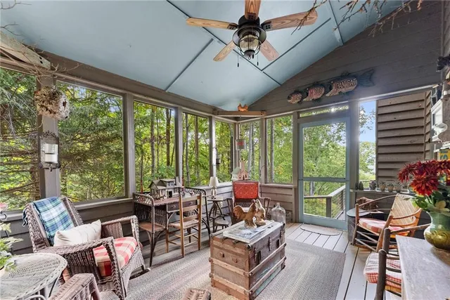 a living room with patio furniture and a potted plant