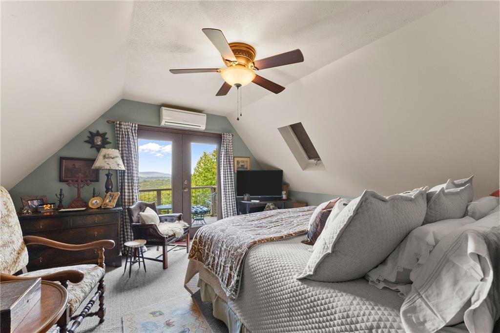 62 High Ridge Road Cleveland, GA 30528 - Photo 29 of 55 a bedroom with a bed gym equipment and a large window