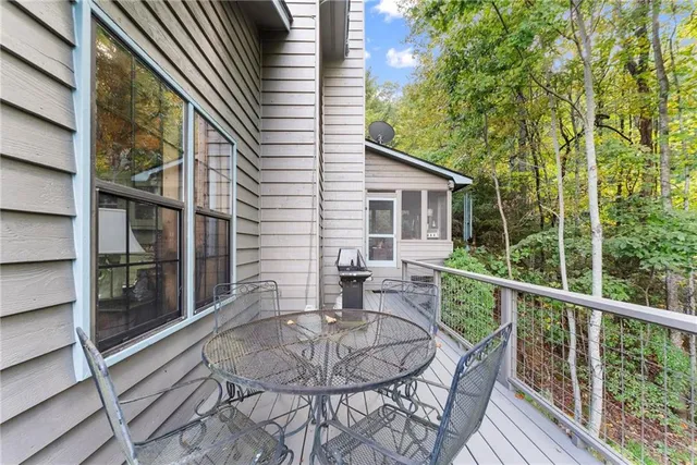 a view of a balcony with wooden floor and fence