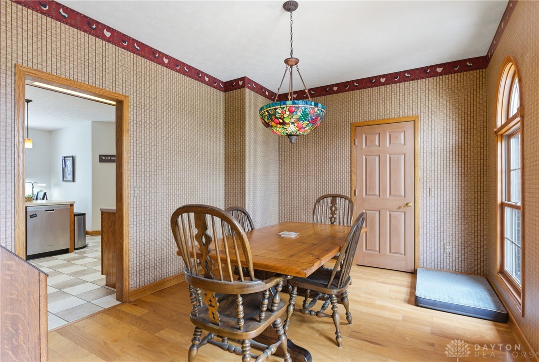 1540 Jasper Road Xenia, OH 45385 - Photo 40 of 91 This dining area features hardwood flooring and an arched window, creating a charming and inviting space.