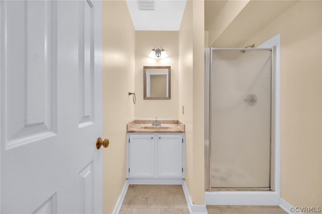 5824 Mill Spring Road Midlothian, VA 23112 - Photo 15 of 29 a bathroom with a granite countertop sink a shower and a mirror