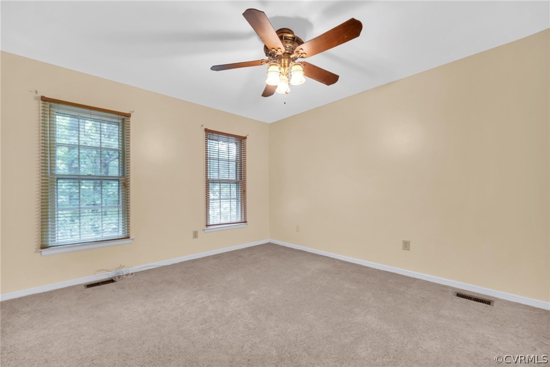 5824 Mill Spring Road Midlothian, VA 23112 - Photo 23 of 29 an empty room with windows and ceiling fan