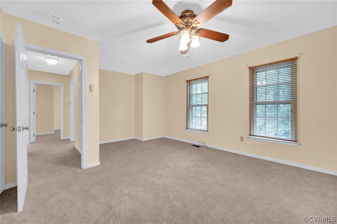 5824 Mill Spring Road Midlothian, VA 23112 - Photo 25 of 29 an empty room with chandelier fan and windows