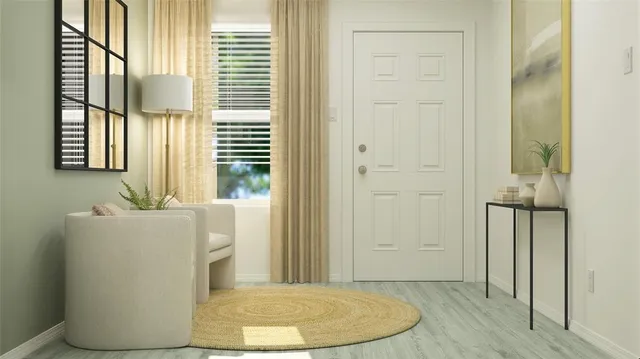 an entryway with wooden floor and windows