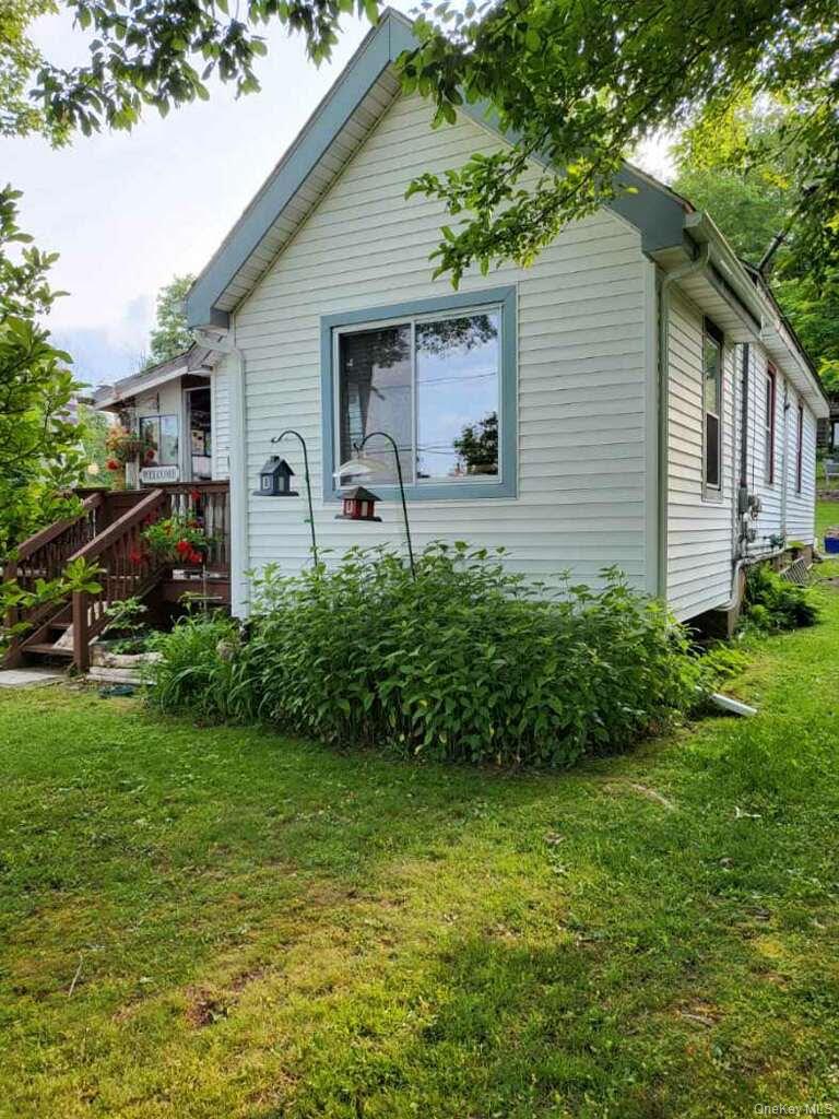 174 Rock Ridge Avenue Monticello, NY 12701 - Photo 2 of 11 a front view of house with garden