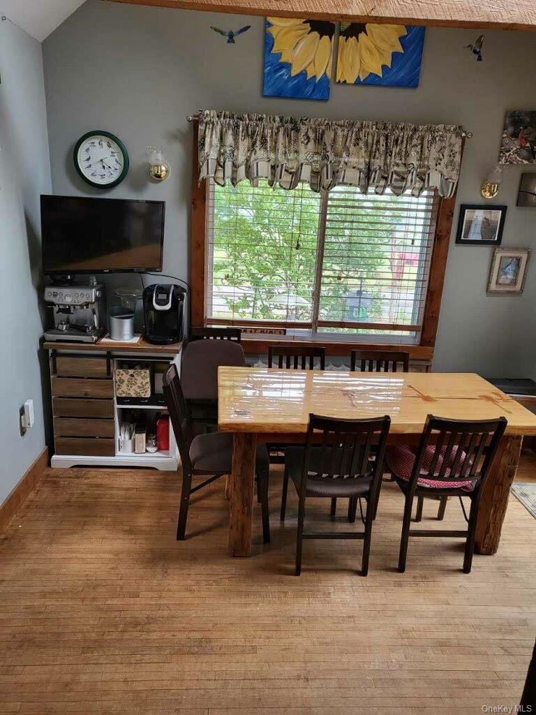 174 Rock Ridge Avenue Monticello, NY 12701 - Photo 4 of 11 a view of a dining room with furniture window and wooden floor