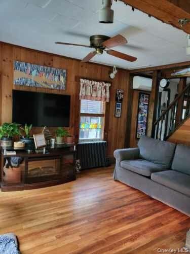 174 Rock Ridge Avenue Monticello, NY 12701 - Photo 5 of 11 a living room with furniture and a flat screen tv