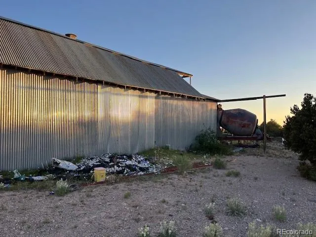 a backyard of a house with chairs and a small yard