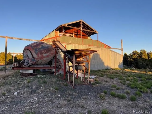 a view of a house with a yard and sitting area